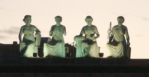 green-goddess-statues-lighted-on-rooftop-of-river-plaza-building